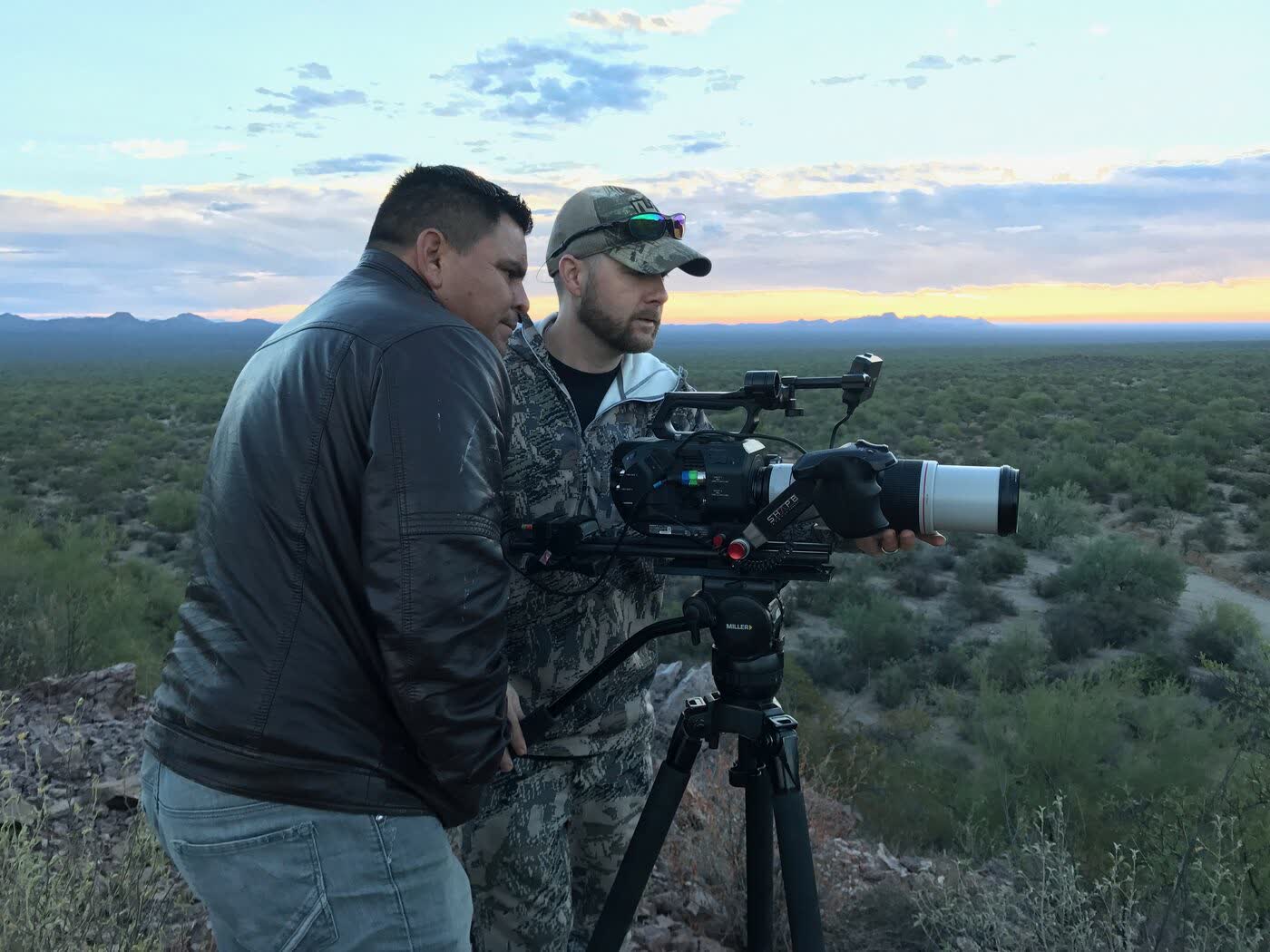 Crew reviewing a shot in the desert at sunset