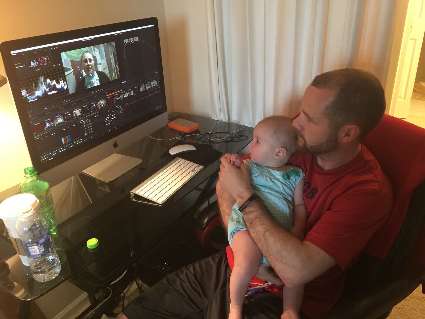 Editor reviewing a cut at home with his son